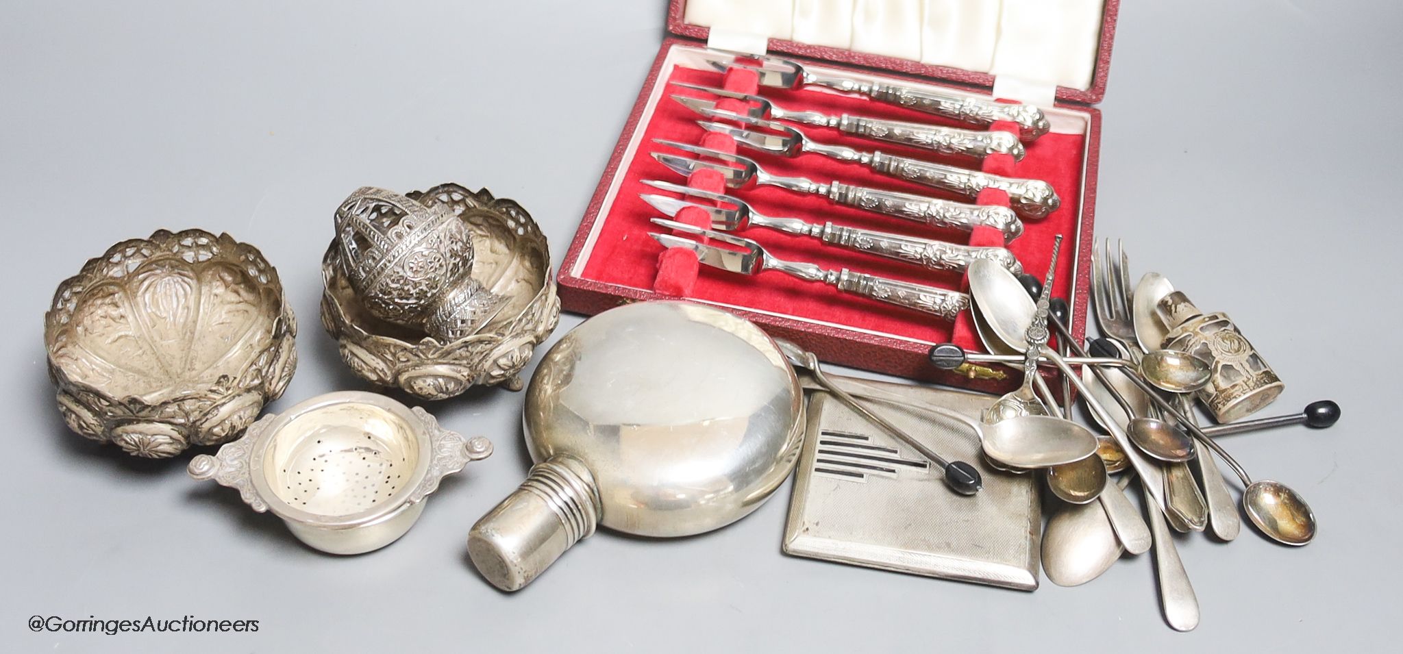 Assorted small silver including a sterling hip flask, cased silver handle tea forks, Art Deco silver cigarette case, teaspoons, tea strainer, overlaid glass scent and three Indian? white metal items, including a pair of
